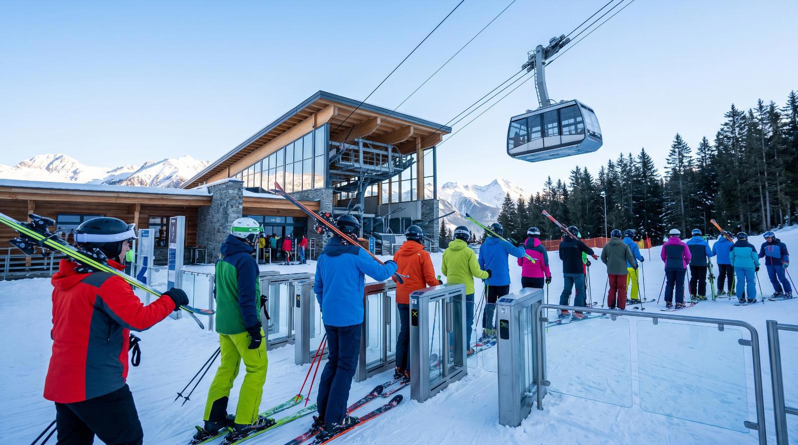 Skiers passing through the gates of the ski lifts in Verbier, ski pass